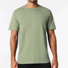 Load image into Gallery viewer, Man wearing a green t-shirt against a white background