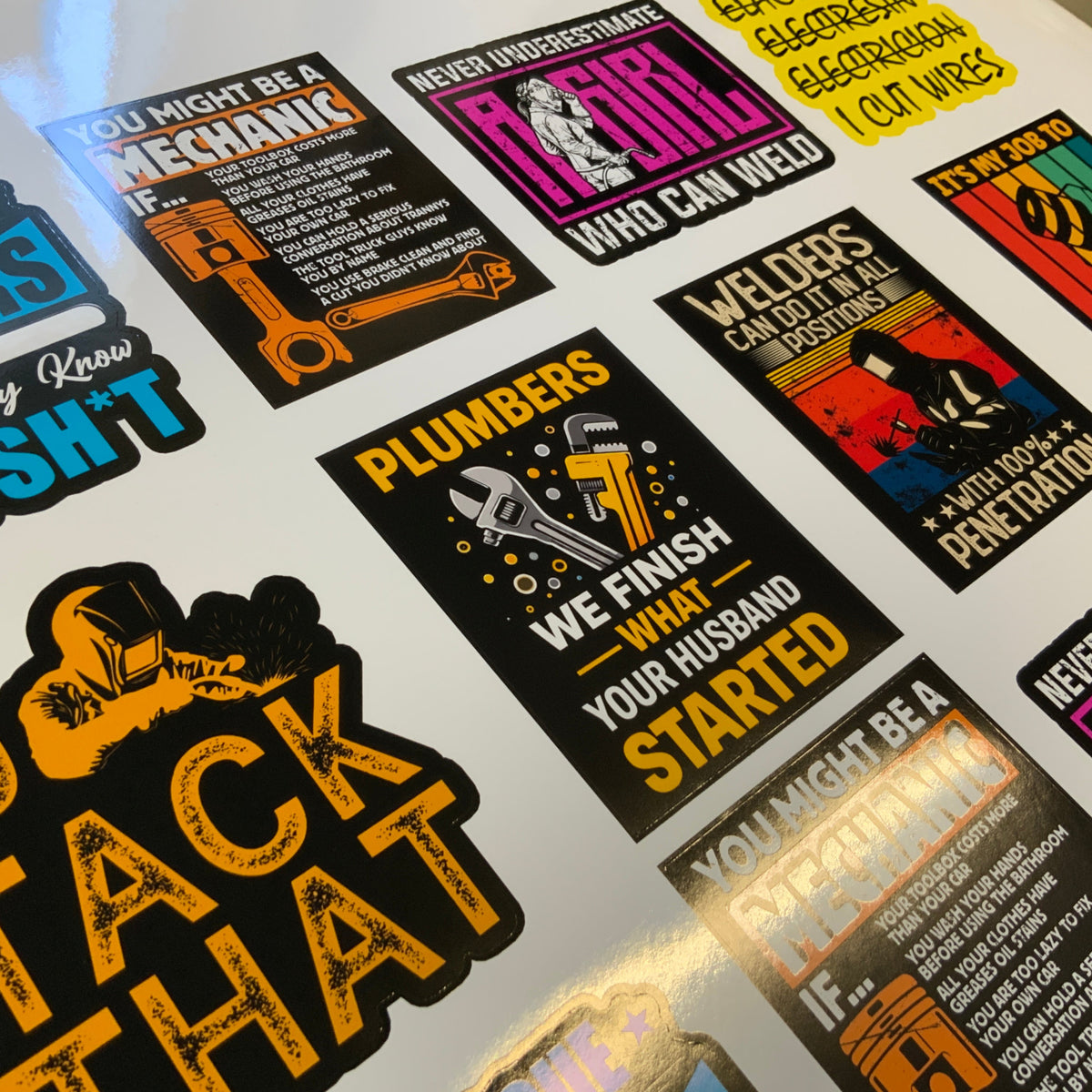 A close-up of a sheet of die-cut stickers displayed on a white surface. The stickers feature humorous and sarcastic quotes for various trades like plumbers, electricians, mechanics, and welders, in bold black, yellow, orange, and blue colors.