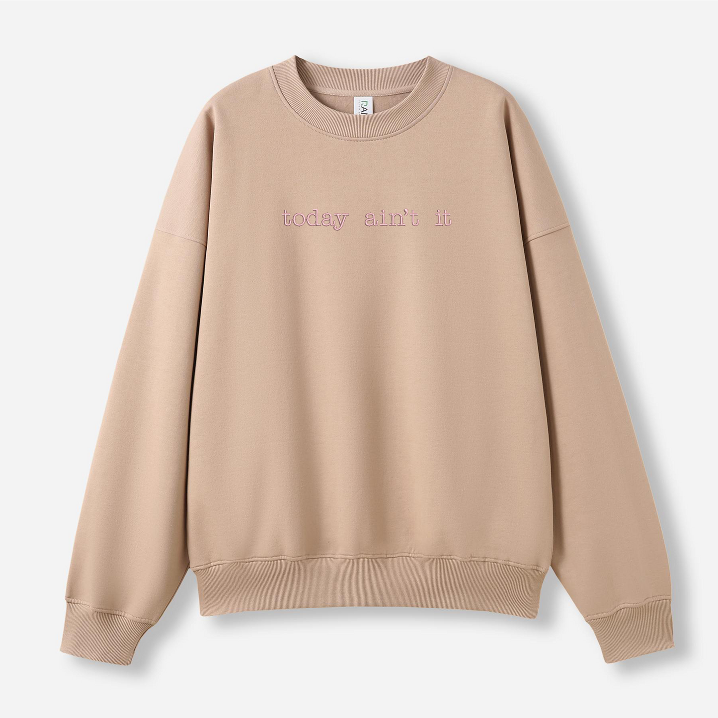 Beige sweatshirt with text on a light gray background