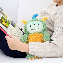 Load image into Gallery viewer, Child holding a plush toy and a book on a white surface
